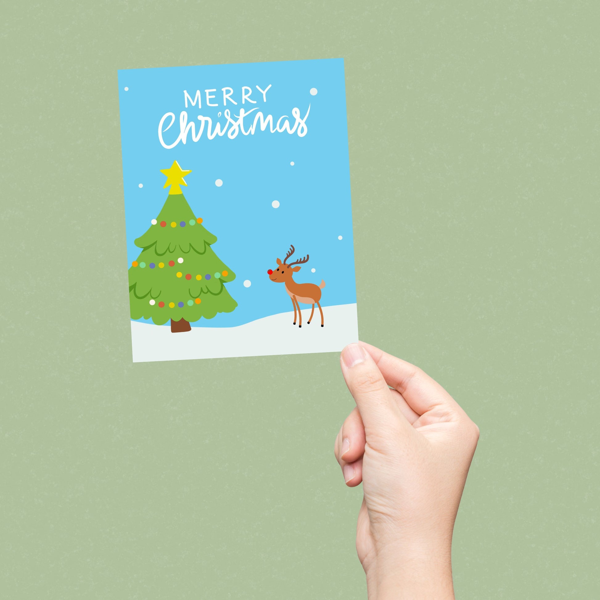 Christmas greeting card with a snowy landscape, decorated Christmas tree, and a cute red-Nosed Reindeer, featuring the phrase 'Merry Christmas' in bold letters, perfect for spreading festive cheer and holiday wishes.