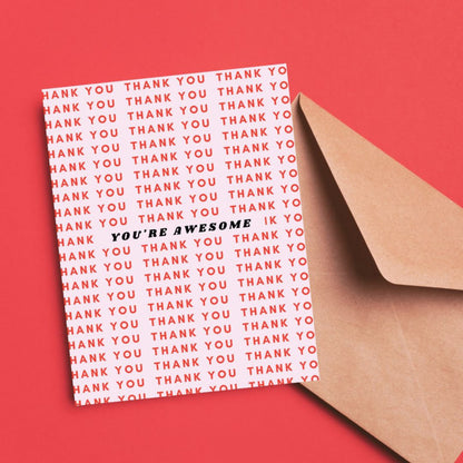 Greeting card with a light pink background featuring Thank You written in red multiple times and You're Awesome in bold black letters at the center. Perfect for expressing gratitude with style.