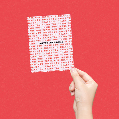 Greeting card with a light pink background featuring Thank You written in red multiple times and You're Awesome in bold black letters at the center. Perfect for expressing gratitude with style.
