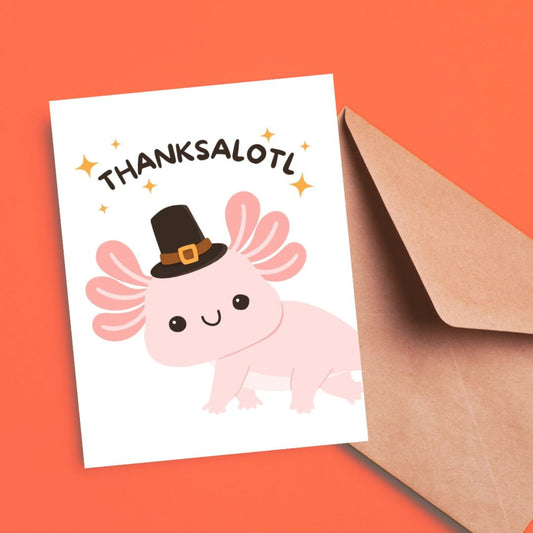 Cute Thanksgiving greeting card with an axolotl in a pilgrim hat, holding the phrase Thanksalotl, perfect for sharing gratitude with a funny twist.