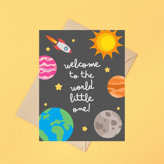 "Welcome to the World Little One" greeting card featuring cute hand-drawn planets and a rocket design, perfect for celebrating a newborn baby with a fun, space-themed touch. Ideal for baby showers, new parents, or welcoming a little astronaut.