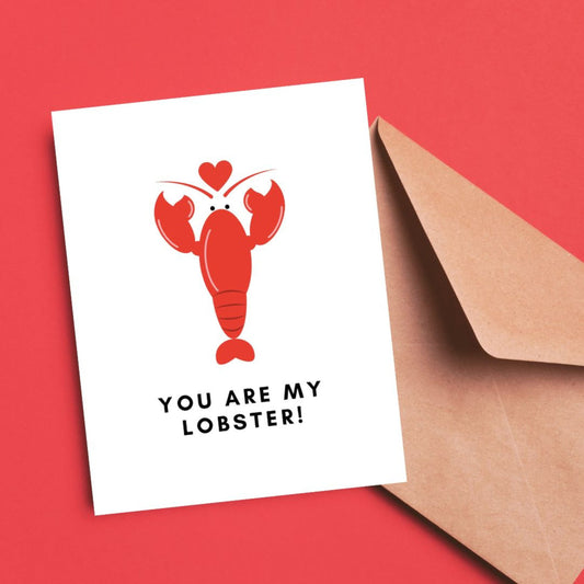 Greeting card with the phrase You Are My Lobster featuring a red lobster holding a heart. Inspired by the TV show Friends, perfect for expressing love and humor.