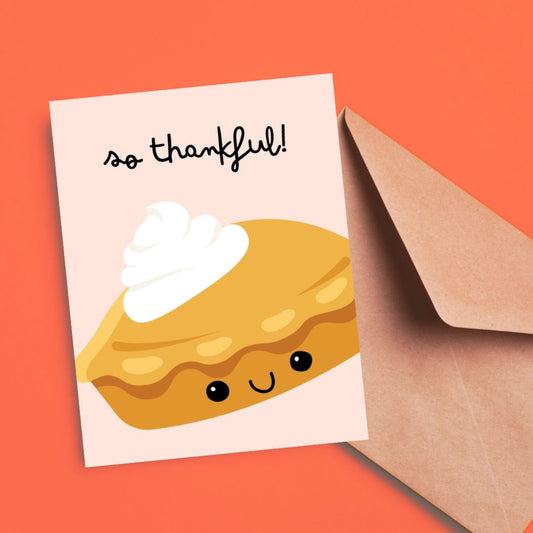 Thank you card with a cute smiley pie illustration topped with whipped cream and the phrase 'So Thankful.' Perfect for expressing gratitude, this whimsical greeting card is ideal for Thanksgiving, pie lovers, and appreciation notes.