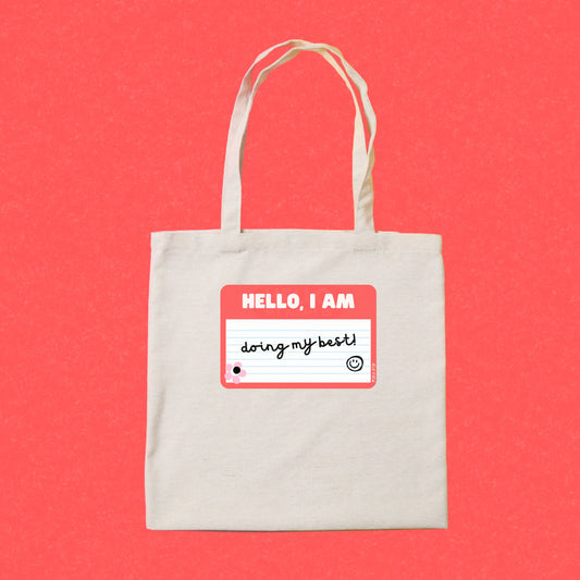 Tote bag with a drawing of a red name tag that reads Hello, I am Doing My Best – perfect for adding a touch of humor and positivity to your day.