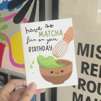 Cute birthday greeting card featuring a smiley matcha drink and the phrase Have So Matcha Fun On Your Birthday, perfect for tea lovers and pun enthusiasts.