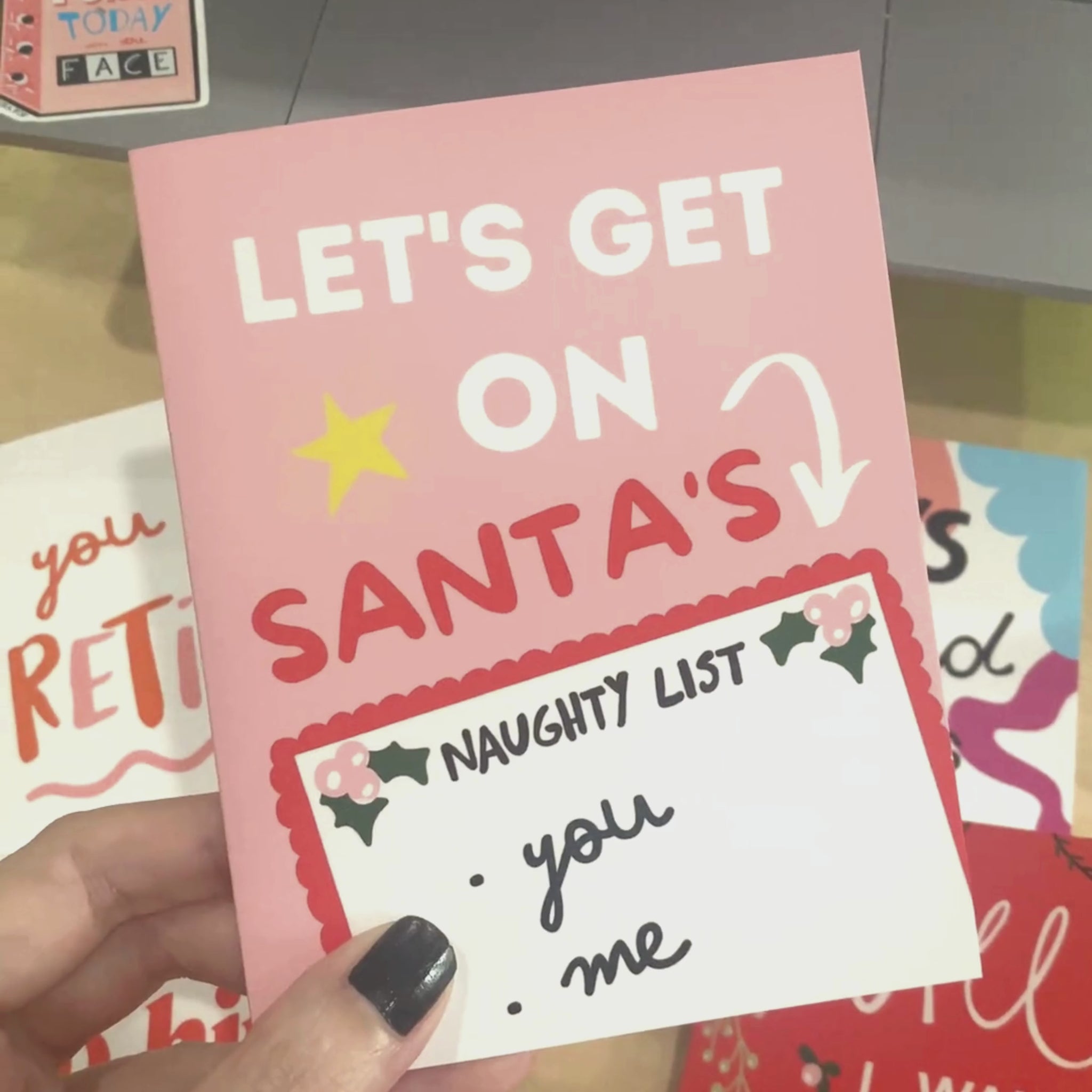 Let's Get On Santa's Naughty List Christmas card with a pink background, featuring Santa's Naughty List with you and me written on it. Perfect for a humorous and playful holiday greeting.