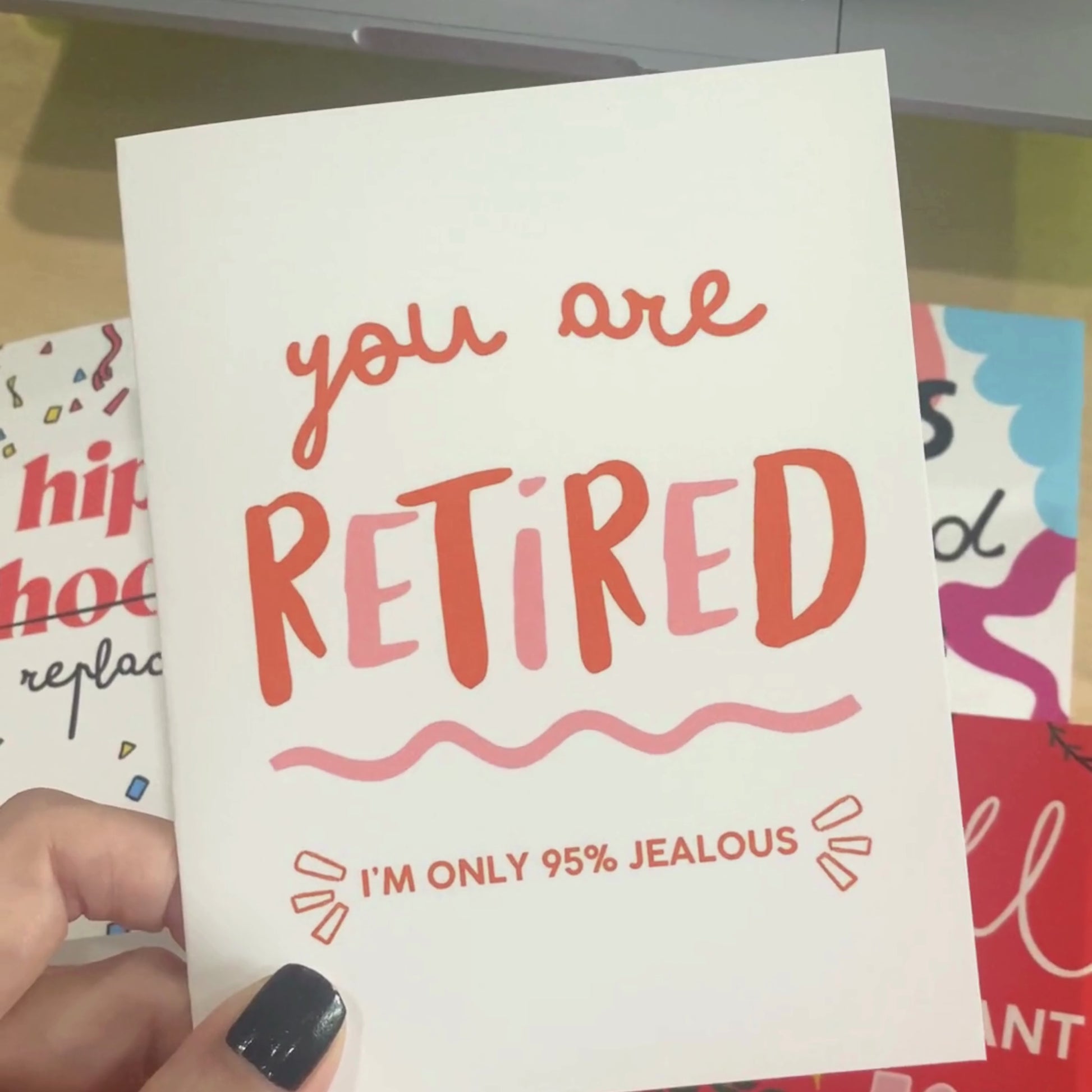 Greeting card with the phrase You Are Retired, I'm Only 95% Jealous in bold letters, perfect for a humorous retirement celebration.