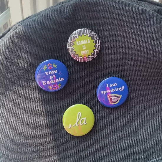 Kamala Harris campaign pin-back buttons, featuring slogans: 'Kamala is Brat,' 'Vote for Kamala,' 'La,' and 'I am Speaking.' Political accessory ideal for jackets, bags, and hats. Bold, high-quality buttons for showing your support in style.