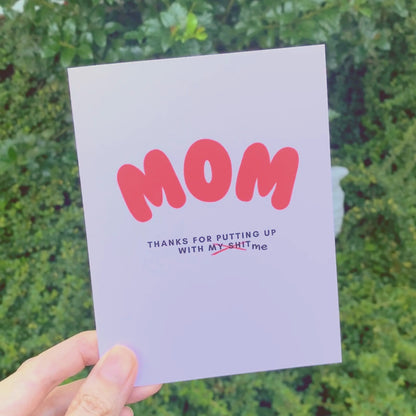 Bold and funny greeting card for mom with MOM in big red letters and the phrase Thanks for putting up with my shit, perfect for Mother's Day, birthday, or everyday appreciation. Ideal for showing gratitude with a humorous twist.