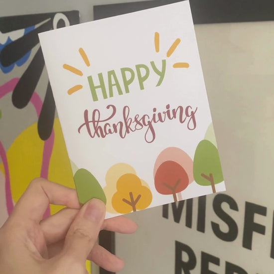 Cute Thanksgiving greeting card featuring fall trees with colorful leaves and the phrase Happy Thanksgiving. Perfect for sharing gratitude and adding a touch of humor to the holiday season.