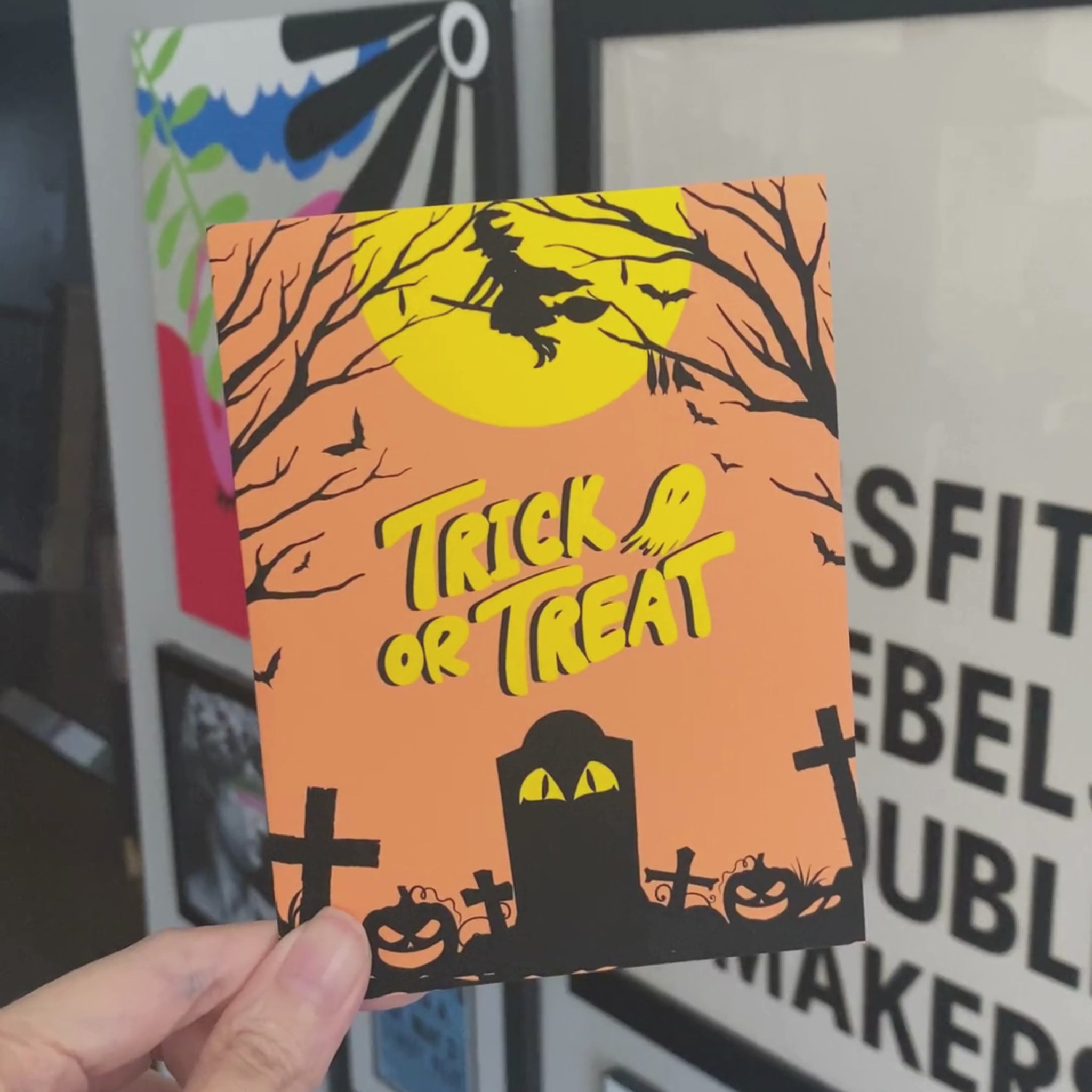 Halloween greeting card with a spooky cemetery scene, glowing full moon, and a witch flying by on her broomstick, featuring the phrase Trick or Treat in bold letters. Perfect for sending Halloween wishes to anyone who loves the spooky season.