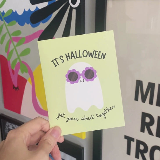 Cute Halloween greeting card featuring a ghost wearing flower-shaped sunglasses with the phrase It's Halloween, Get Your Sheet Together, funny spooky design perfect for sending Halloween laughs.