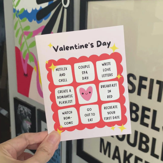 Valentine's Day greeting card featuring a cute bingo card design with fun date ideas, including Recreate Your First Date, Couple Spa Day, Watch Rom-Coms, and Netflix and Chill. Ideal for couples looking to add a fun twist to their celebration.